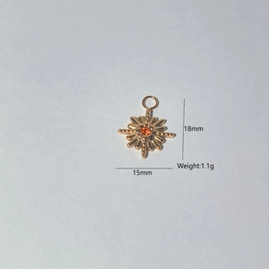 Detail of 18k gold sunburst pendant with red stone, dimensions 18x15mm and 1.1g weight