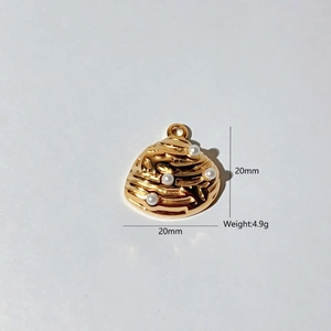 Detailed view of golden seashell pendant with four white pearls and size markings