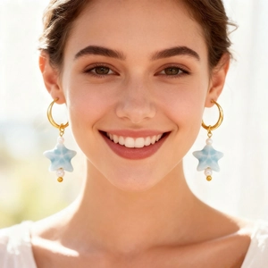 Elegant stainless steel gold hoop earrings with white pearls and blue star pendants