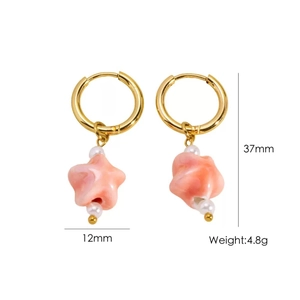 Detail of gold starfish earrings with pink resin pendant and pearls measuring 37mm