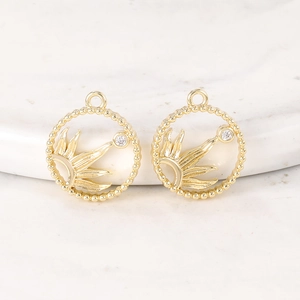 Pair of gold circular pendants with sunburst design and zircon stones for DIY jewelry