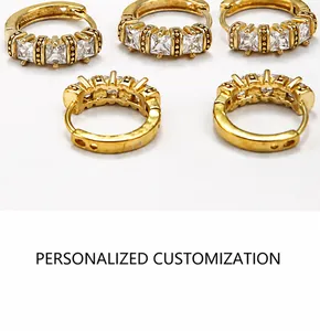 Detail of gold-plated hoop earrings featuring three square-cut inlaid zircons on metal