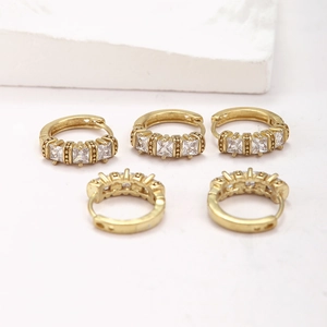 Minimalist gold brass hoop earrings featuring three square cubic zirconia stones