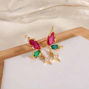 Detail of gold drop earrings with leaf design, colorful zircons and star charms