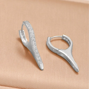 Silver spike hoop earrings featuring pave-set cubic zirconia in a minimalist style