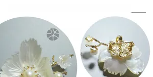 Detail view of gold-plated lotus flower brooch with shell petals and pearl center