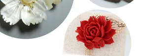 Detail of DIY jewelry findings featuring white pearl flowers and red rose pendants with leaves