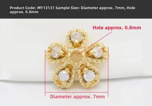 Detailed macro view of 7mm gold plated flower spacer bead with sparkling zircon crystals