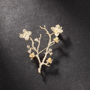 Elegant gold flower branch brooch with brushed texture and detailed floral design