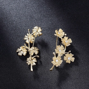 Exquisite gold-plated flower brooch pins with sparkling zircon accents on leather