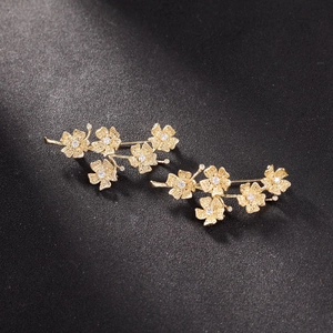 Gold plated matte flower brooch and accessory with sparkling white stone inlay