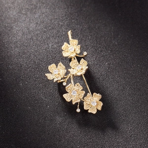 Exquisite gold-plated floral brooch with matte petals and sparkling cubic zirconia stones
