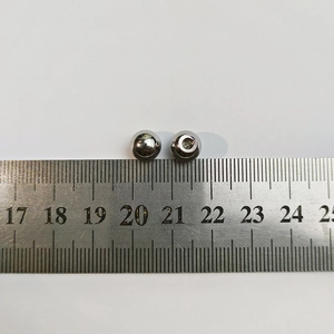 Detailed macro view of 6-8mm polished stainless steel ball beads with inner screw thread