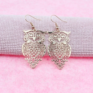 Elegant rose gold owl drop earrings featuring intricate hollow metal craftsmanship