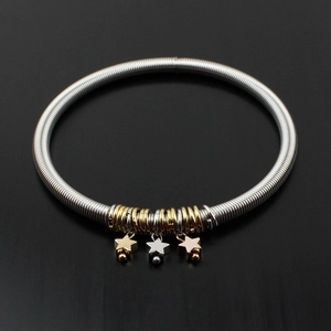 Silver guitar string spring bracelet with tri-color star pendants in gold and rose gold
