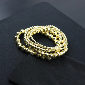 Detail view of 14K gold plated bracelets featuring faceted hematite beads and polished spheres