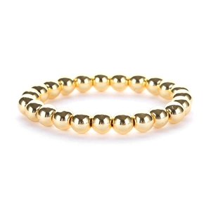 Bracciale minimalista con perline sferiche lucide placcate in oro 14K su sfondo bianco