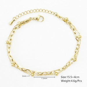 Detail of double-layer gold stainless steel chain bracelet with metallic beads and clasp