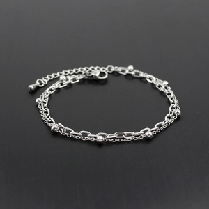 Minimalist double-layered silver stainless steel bracelet featuring beads and lobster clasp