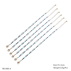 Detailed set of blue and grey beaded bracelets with gold lobster clasps and extension chains