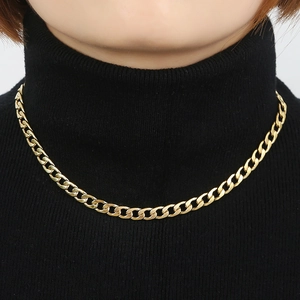 Polished gold cuban link necklace for women on a model with black turtleneck