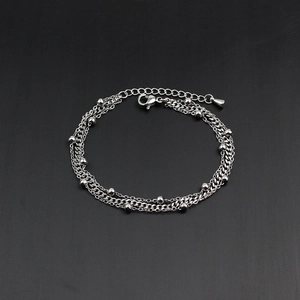 Detail of a multi-layer beaded chain bracelet with lobster clasp and adjustable link