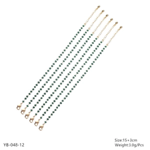 Detail of 6 gold beaded bracelets with green crystals, lobster clasp and extension chain