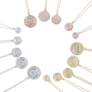 Vintage Dos Pesos coin necklaces in gold, silver and rose gold finishes on white background