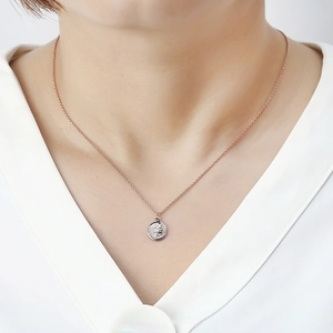 Rose gold minimalist necklace featuring a vintage queen coin pendant worn by a model