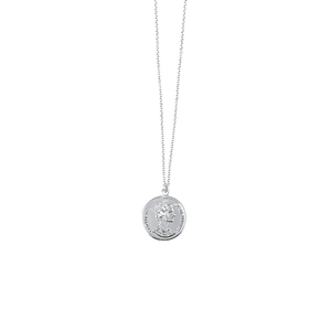 Detailed macro view of silver portrait coin pendant with fine link chain necklace