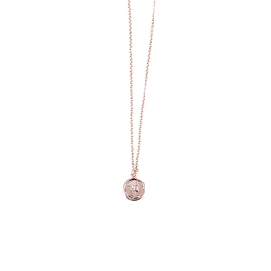 Detailed macro view of the rose gold coin pendant with an elegant embossed profile