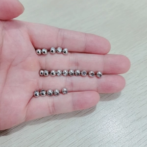High-polished 5mm stainless steel beads for DIY jewelry making shown on fingertips