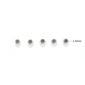 Detailed view of 5mm polished stainless steel beads showing 1.5mm inner hole diameter