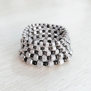 Unisex black and silver stainless steel beaded stretch bracelet with knurled texture