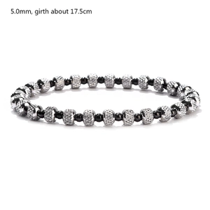 Macro shot of 5mm black round beads and faceted silver metal beads on elastic bracelet