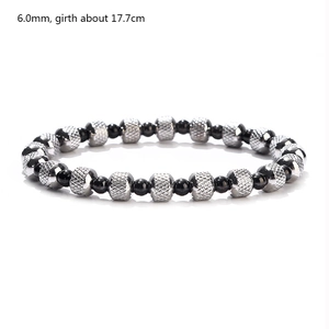 Detail of 6mm black and silver grid textured beads on an elastic stainless steel bracelet