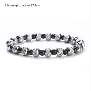 Detail view of 7mm black beads and silver textured metal beads on a stretchy bracelet