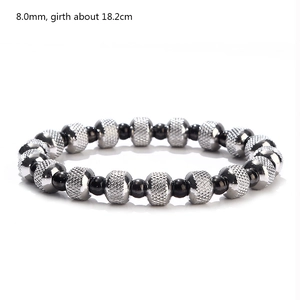 Detail of 8mm waterproof beads and grid engraved metal spheres on beaded stretch bracelet