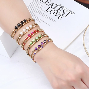 Detail shot of five-piece colorful crystal beaded stretch bracelets on a gold finish base