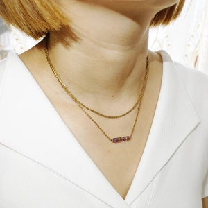 Dettaglio di una collana a doppio strato placcata oro 18K con pietre viola da donna