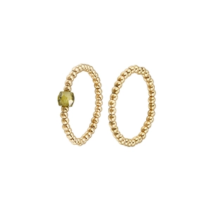 Macro detail of elastic beaded stainless steel rings with yellow zircon and gold finish