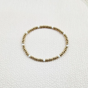 Close-up of handmade stretch bracelet featuring gold stainless steel beads and white stones