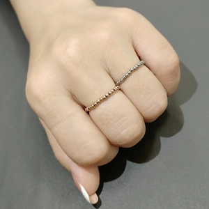 Detail of rose gold and silver beaded stackable stainless steel rings on hand