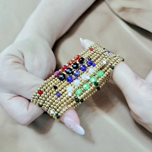Detail view of multi-layer handmade stretch bracelets with colorful faceted crystal beads