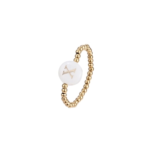 Detail of beaded elastic ring featuring a golden shell disc with the letter X engraving