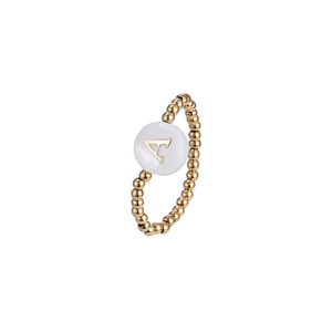 Close-up of golden beaded elastic ring with a white shell disc and letter A detail