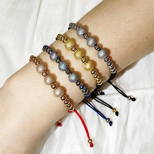 Adjustable woven rope bracelets with sandblasted steel beads in various metallic finishes