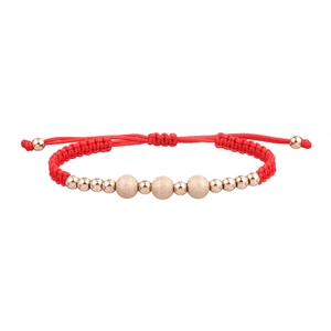 Close-up of red woven rope bracelet with matte gold beads and adjustable sliding knot