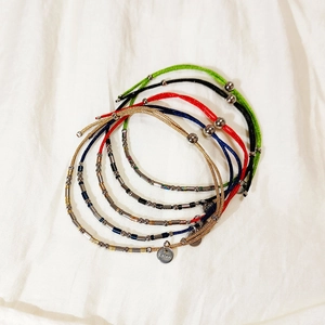 Handmade woven cord bracelets with stainless steel beads and charms in various colors