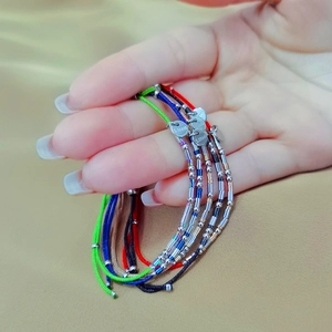 Adjustable stainless steel bead bracelets in multicolor woven cords for women